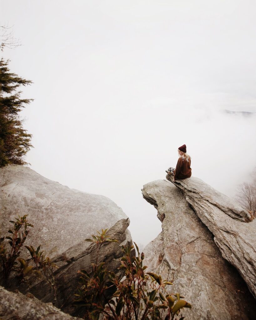 mindfulness, woman sitting on brown rock