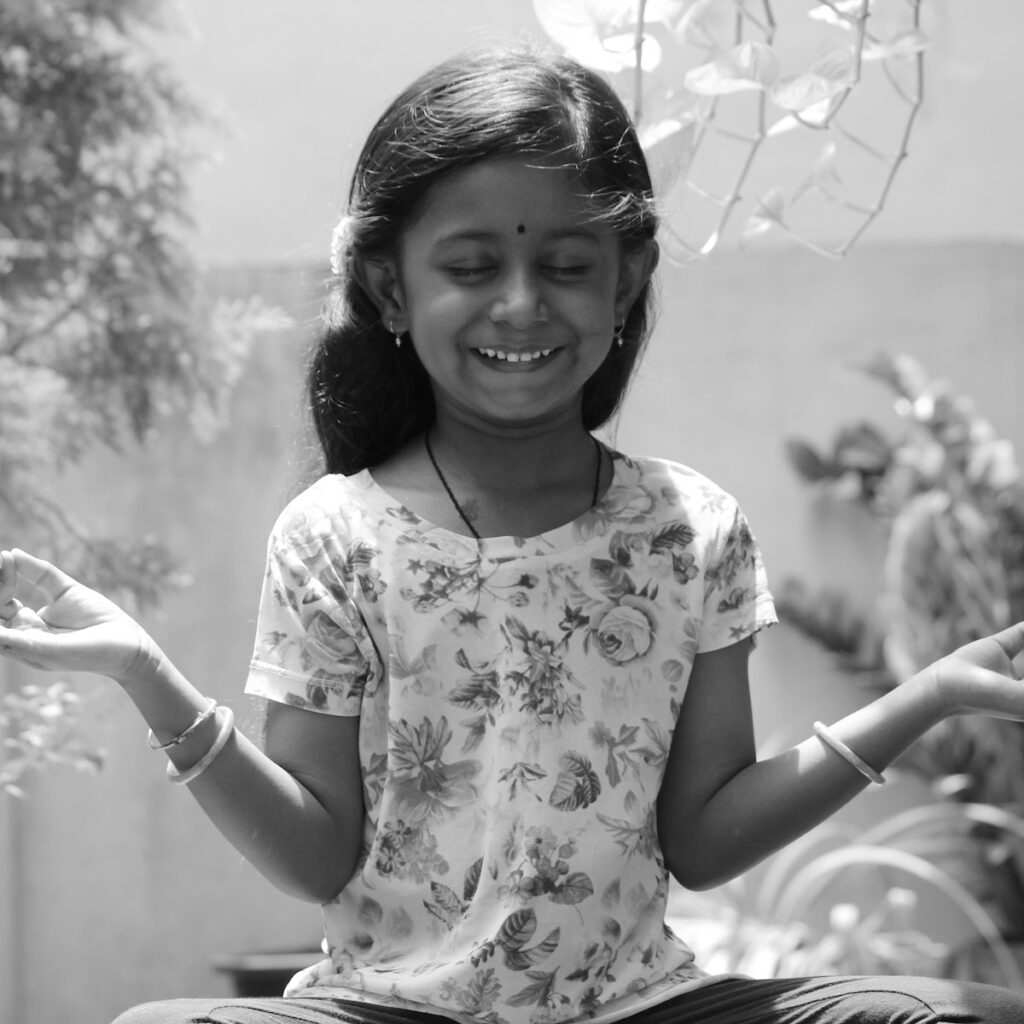 grayscale photo of girl in floral shirt smiling