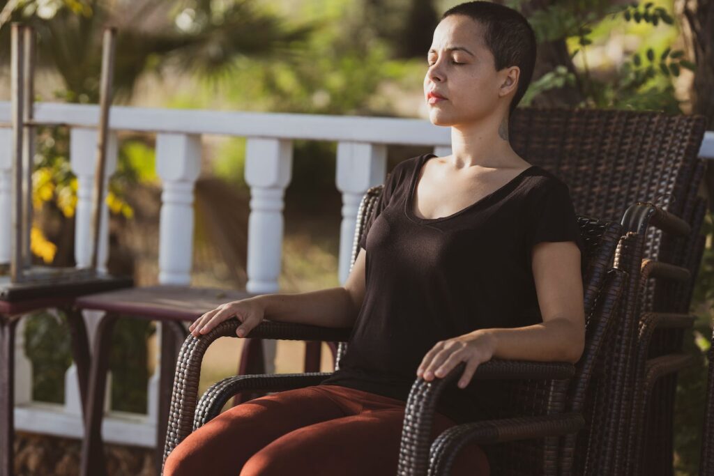 Woman in Black Top Sitting on Brown Armchair