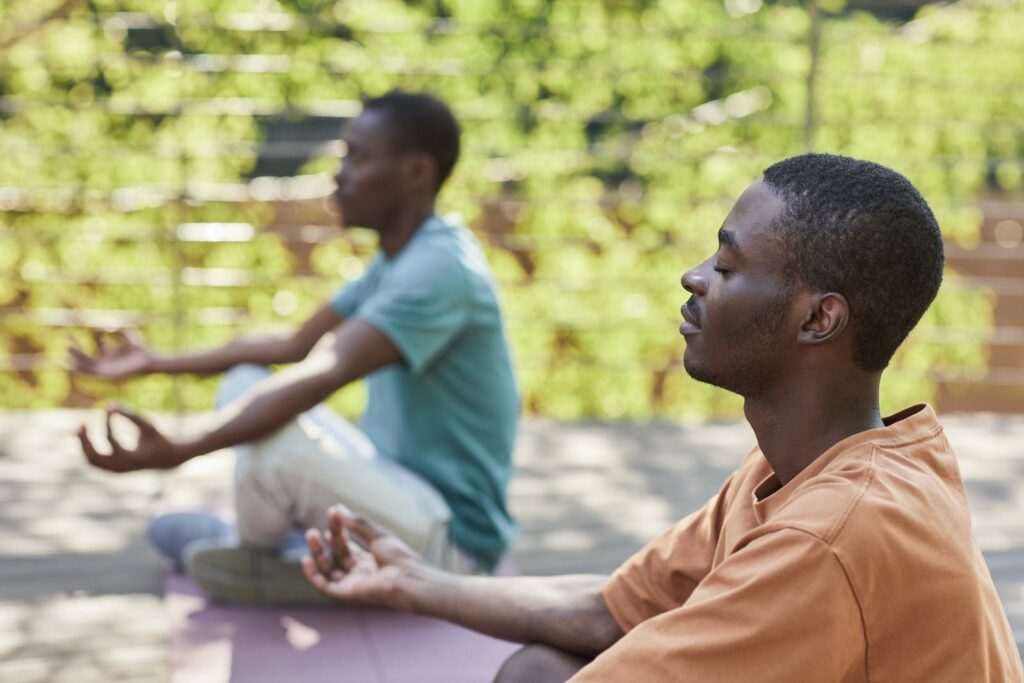 Man in Orange Shirt Meditating