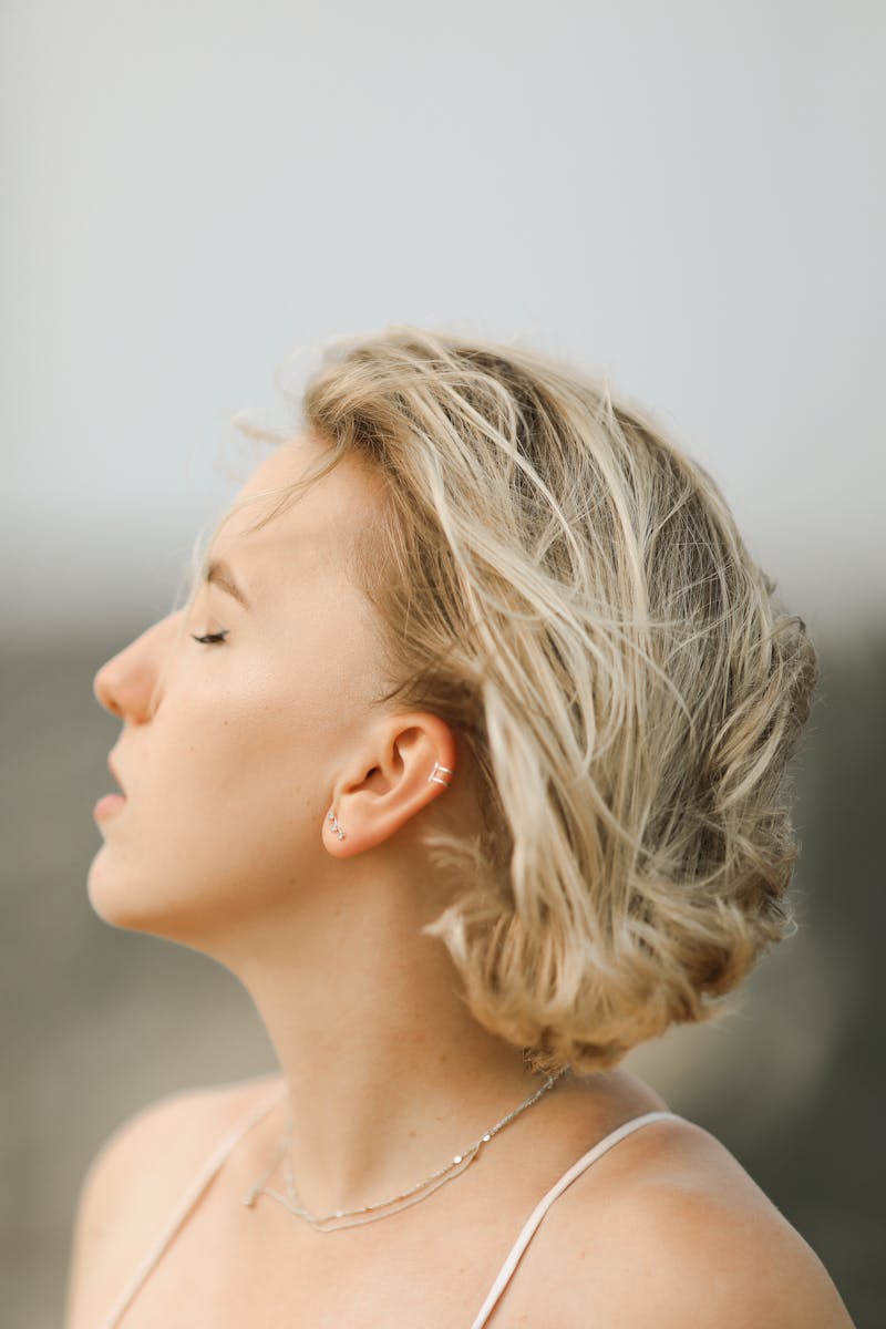 A woman with blonde hair and a white tank top