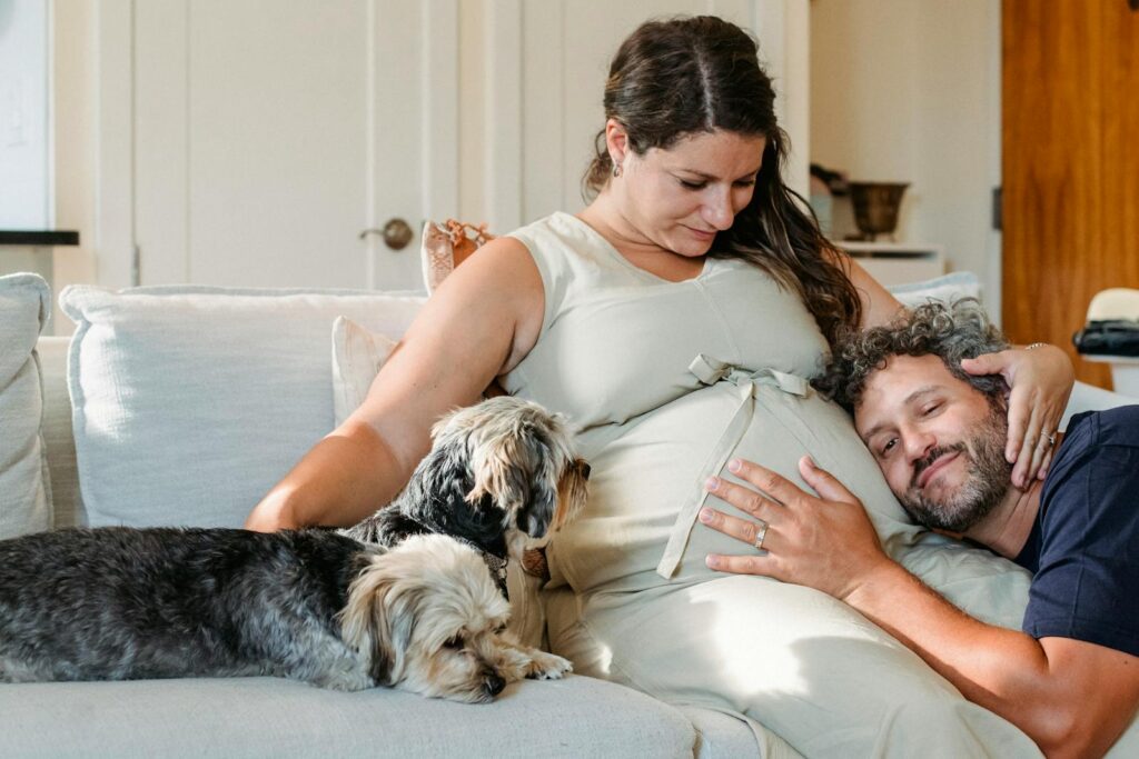 Happy couple on couch with dogs