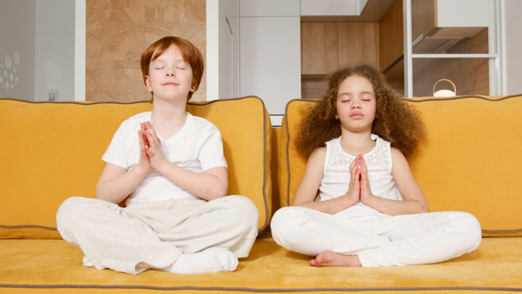 Photograph of Kids in White Clothes Meditating with Their Eyes Closed