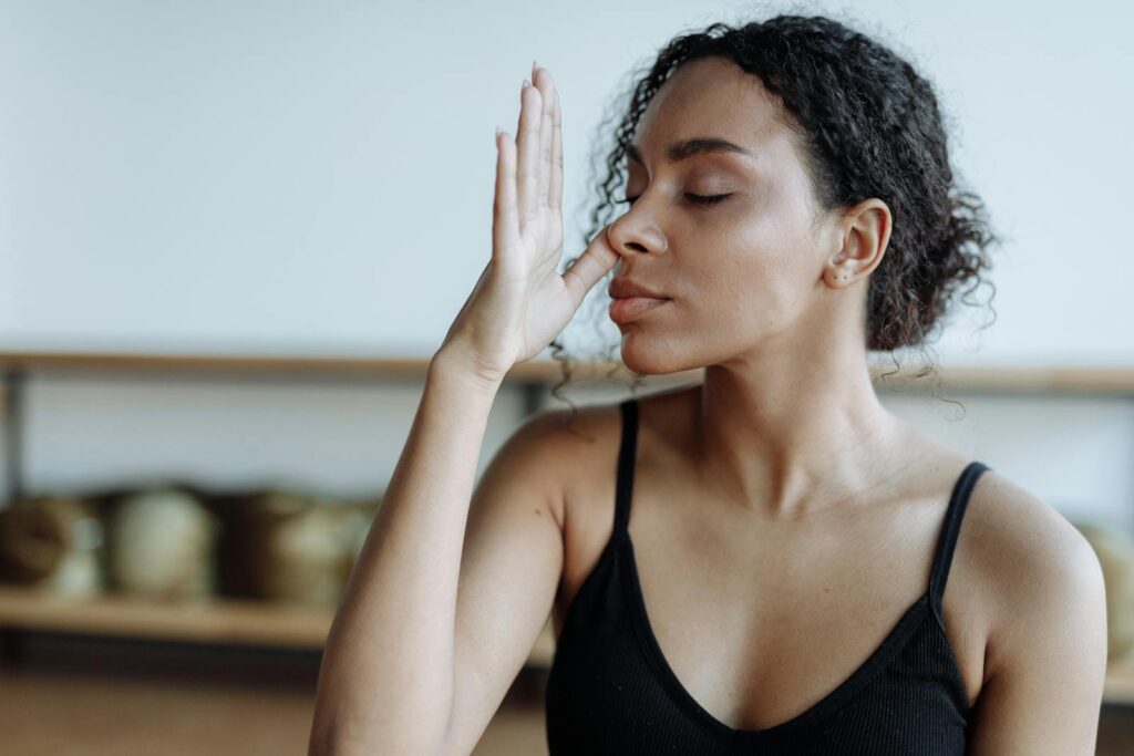 Woman in Black Tank Top Meditating